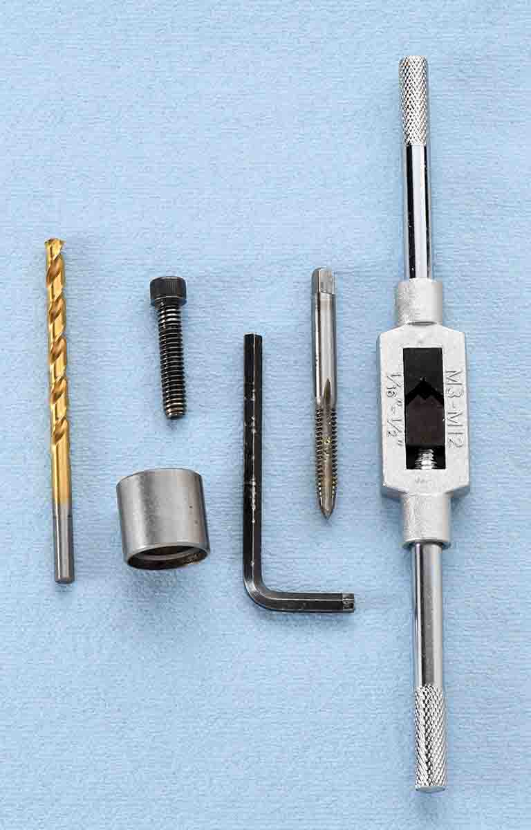 Common tools in a kit for removing stuck cases from sizing dies include a drill bit, steel sleeve with extracting screw or bolt, hex wrench and a tap. A wrench can be purchased separately.